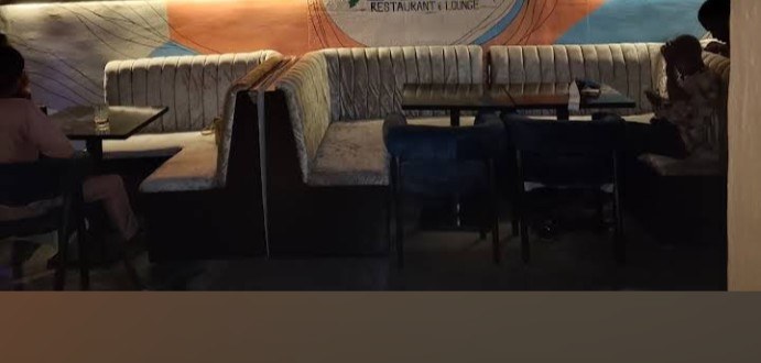 The Retreat name displayed on a feature wall behind lounge seating